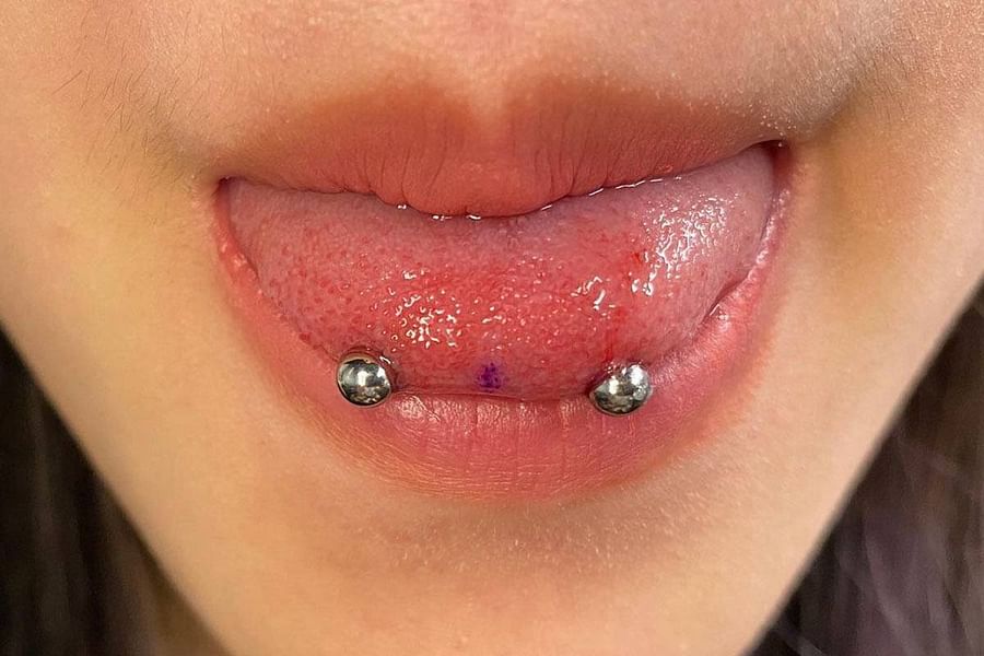 Comparison of Snake Bites and Smiley Piercing on a face
