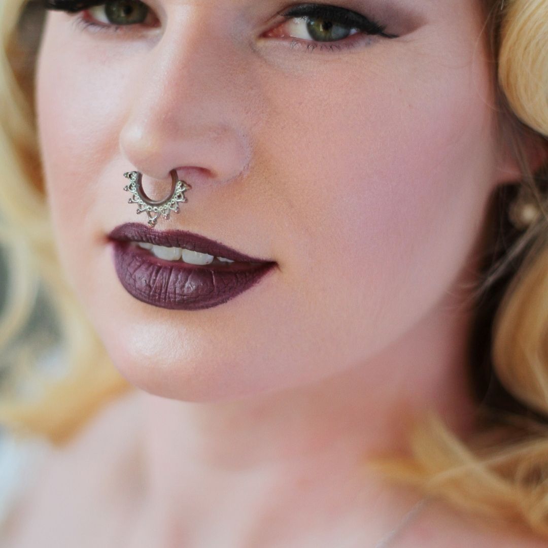 Close-up view of a healing septum piercing